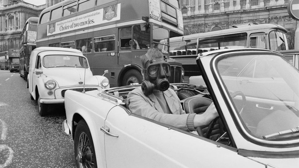 Driver wearing mask, 1970s