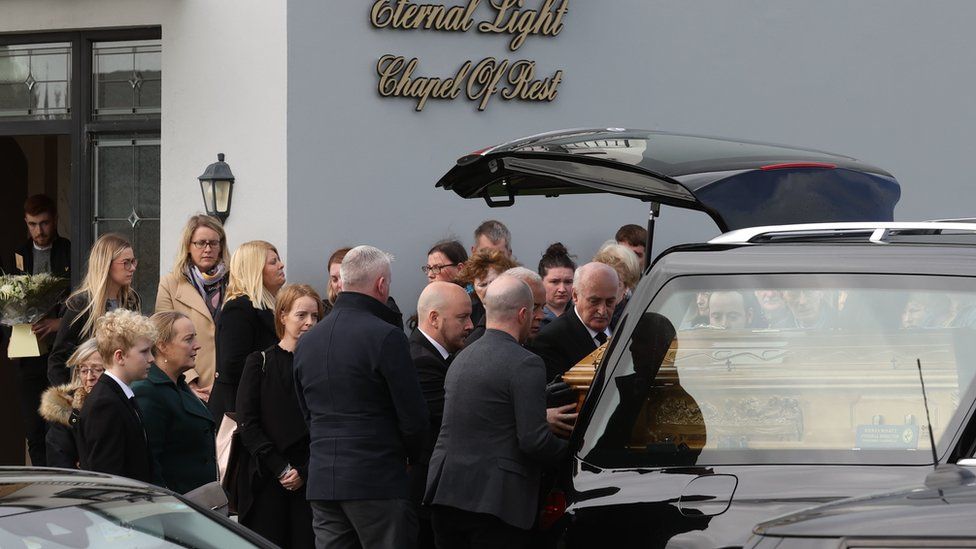 The coffin of James O'Flaherty is removed from the Eternal Light Chapel of Rest in Letterkenny, accompanied by his wife Tracey (front row, third from left) and son Hamish (front row, second from left). Picture date: Monday October 10, 2022.
