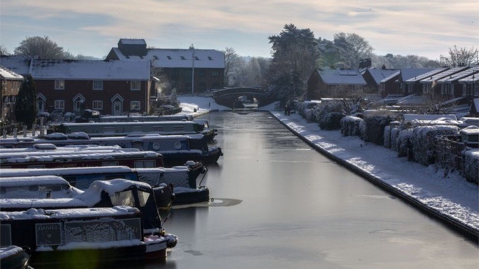Canal boats in the frozen Shropshire Union Canal at Market Drayton