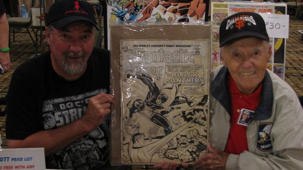 Joe Sinnott (right) and his son Mark holding the original unused cover of Fantastic Four #52, the first appearance of The Black Panther at Albany Comic Con, 2016