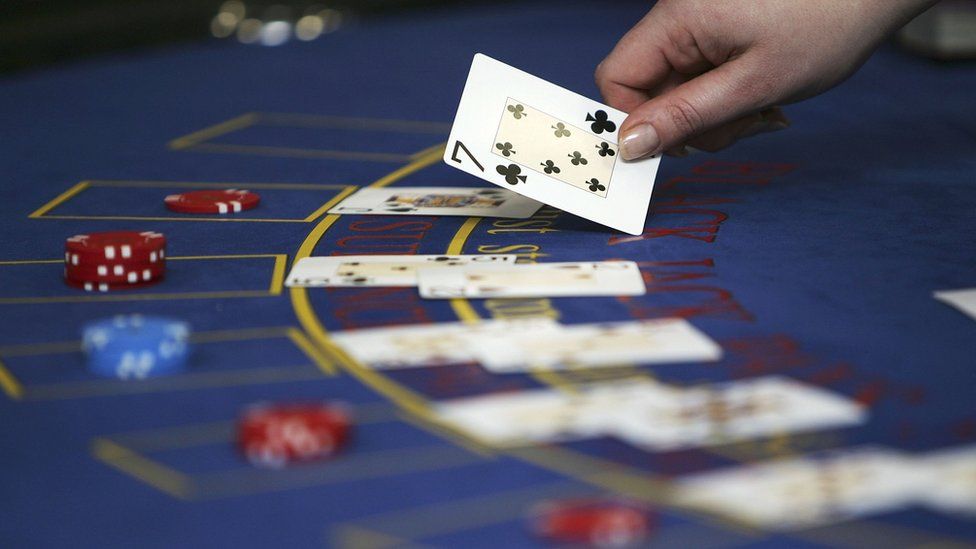 stock image of croupier dealing cards at a Black Jack table
