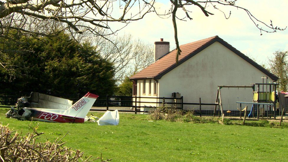 house and plane in front of it