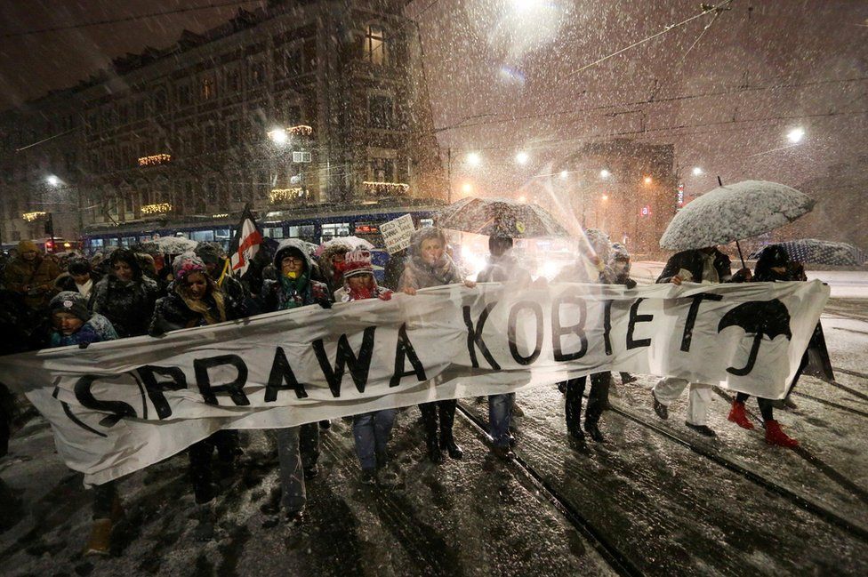 People gather to protest against plans to further restrict abortion laws in Krakow, Poland January 17, 2018. Jakub Porzycki/Agencja Gazeta via Reuters Banner reads "Women"s rights - women"s business" .