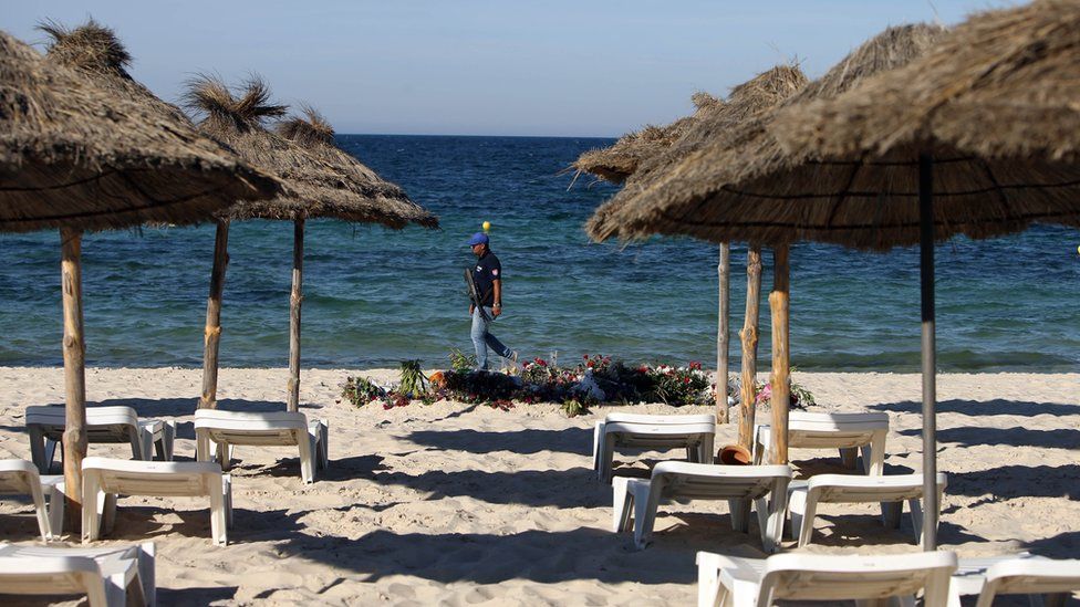 File photo dated 30/06/15 of an armed policeman on the beach near the RIU Imperial Marhaba hotel in Sousse, Tunisia, following a terrorist attack at the beach.