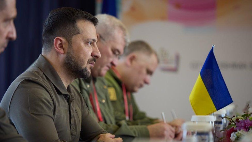 Volodymyr Zelensky and a Ukraine flag