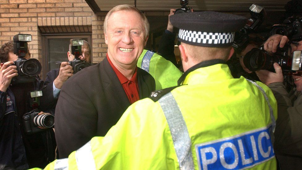 Chris Tarrant arriving at court in March 2003