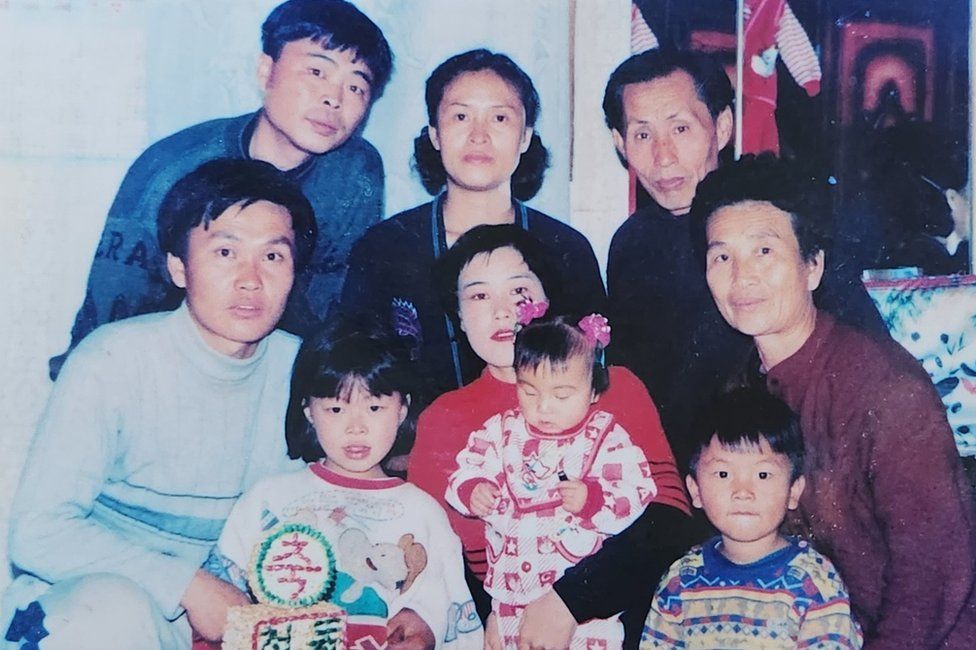 Songmi as a toddler with her parents and the rest of the family