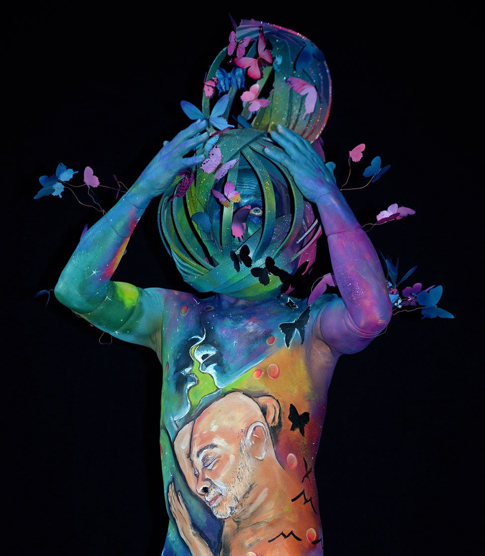 A model, painted by bodypainting artist Ton Nizet from the Netherlands, poses for a picture