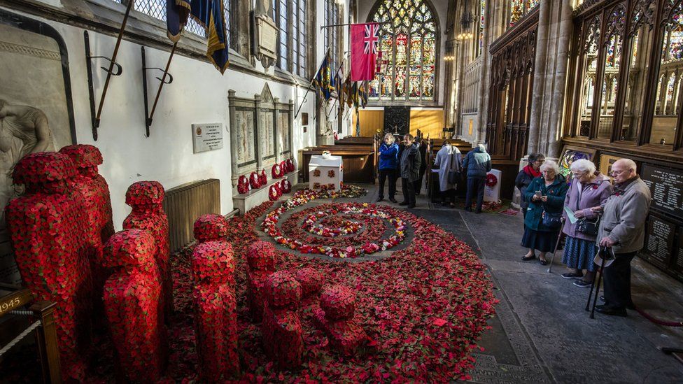 People look at an installation titled Coming Home by artist Martin Waters at Hull Minster.