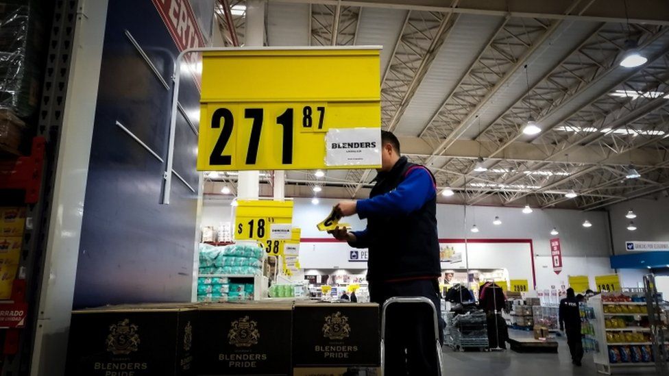 A supermarket employee changes products' price tags due to inflation, in Buenos Aires, Argentina, 14 August 2019