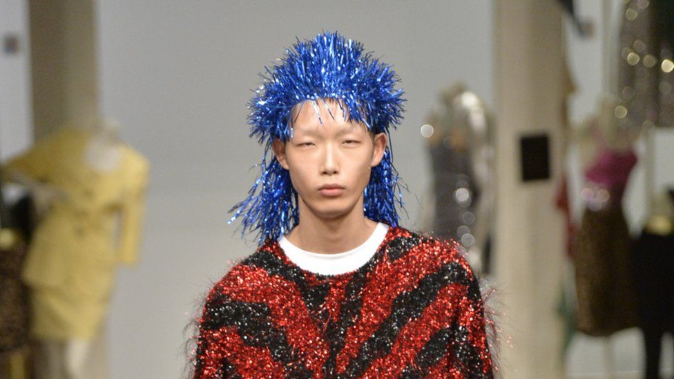 A male model with a tinsel wig