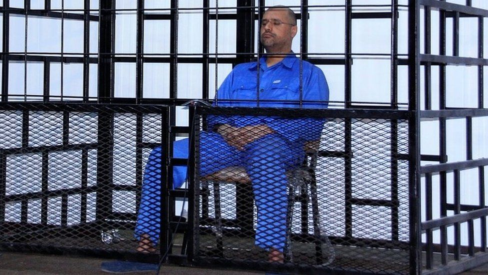 Saif al-Islam Gaddafi, son of late Libyan leader Muammar Gaddafi, attending a hearing behind bars in a courtroom in Zintan May 25, 2014