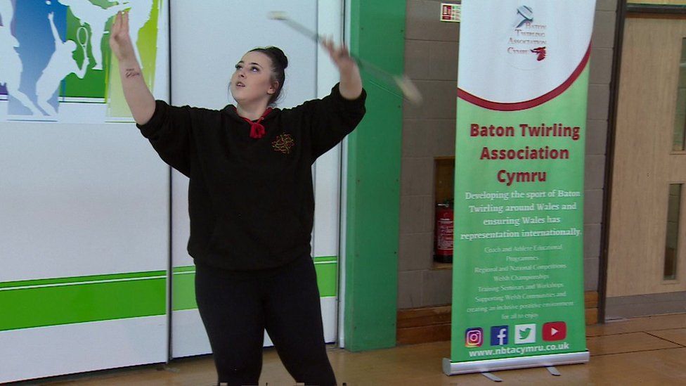 A teenage girl practicing twirling