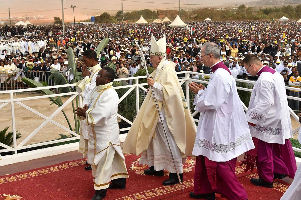Pope walking on alter in front of crowd in Madagascar