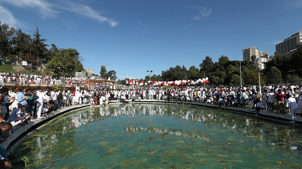 People sprinkle water on their bodies as they take part in the Irreecha celebration, the Oromo thanksgiving ceremony in Addis Ababa