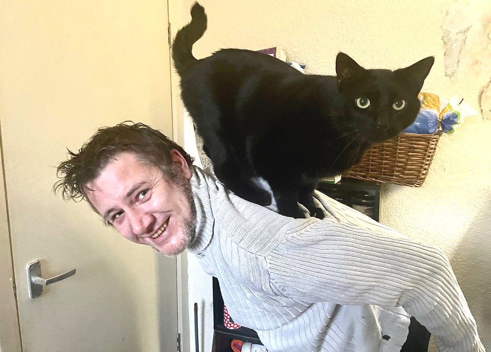 Chris Forrest with his cat, Shadow