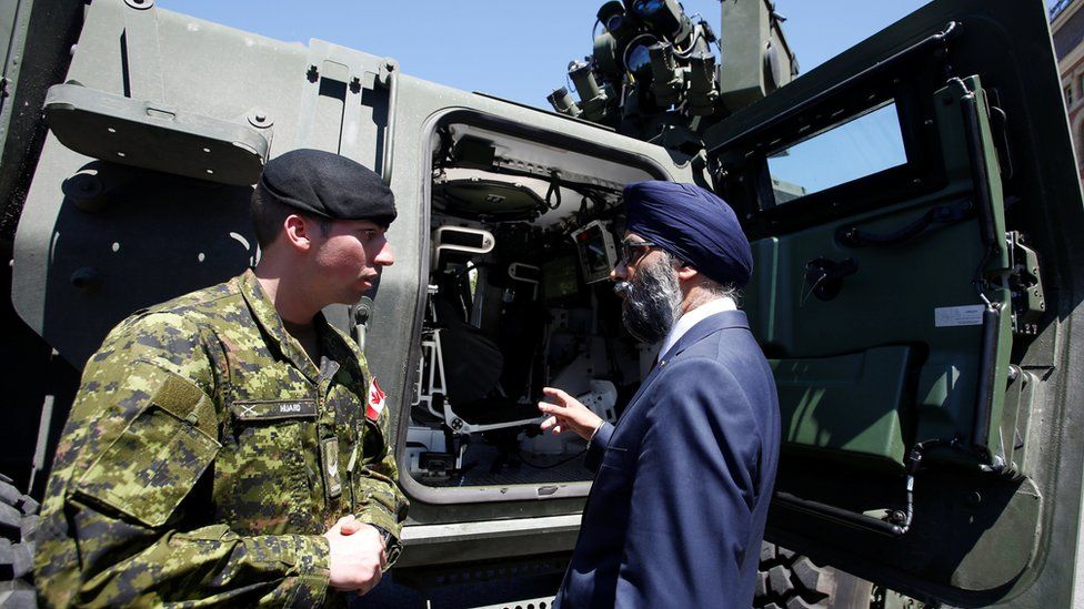 Defence Minister speaks to Corporal Huard after announcing Canada's new defence policy in Ottawa