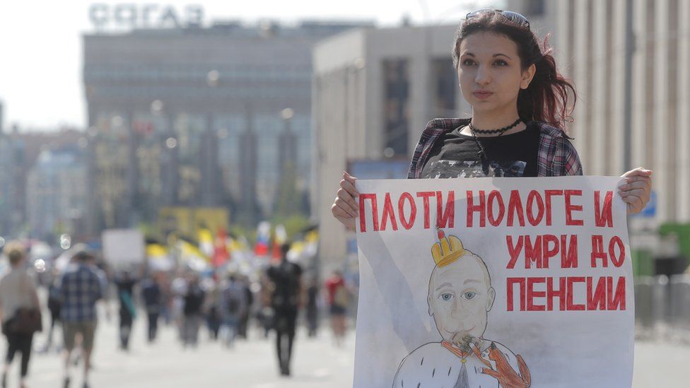 protester holds up a banner in Moscow