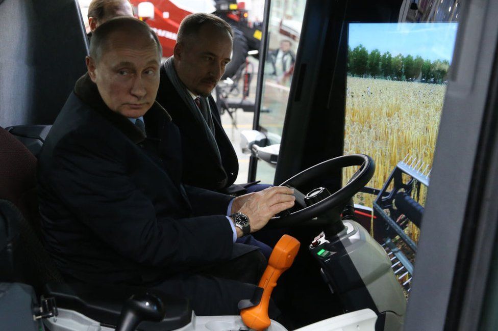 Russian President Vladimir Putin (L) examines a tractor simulator while visiting a tractor plant of Rostselmash on February 1, 2018 in Rostov-on-Don, Russia.