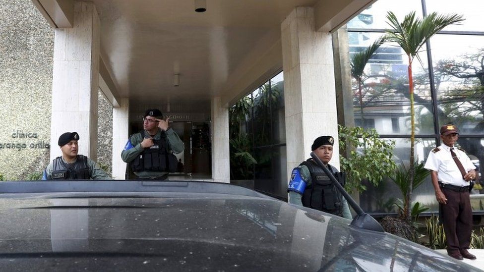 Police officers stand guard at the entrance of the Mossack Fonseca law firm office in Panama City April 12, 2016