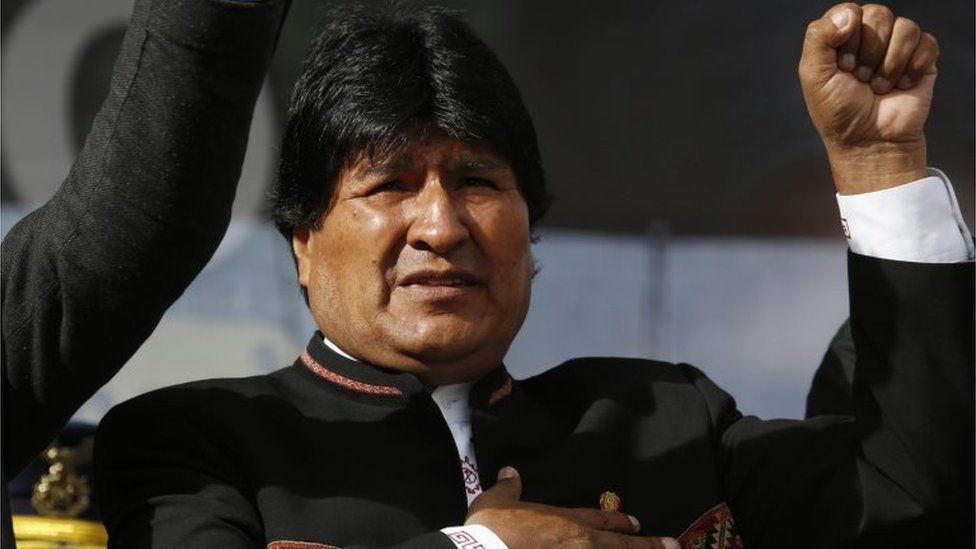 Bolivia's President Evo Morales sings his national anthem at a signing ceremony for the expansion of a road that connects the capital with the nearby city of El Alto, in La Paz, Bolivia, Monday on 22 February, 2016