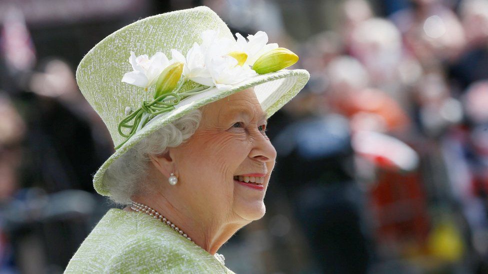 Королева Елизавета улыбается, приветствуя доброжелателей в свой 90-й день рождения во время прогулки в Виндзоре, к западу от Лондона