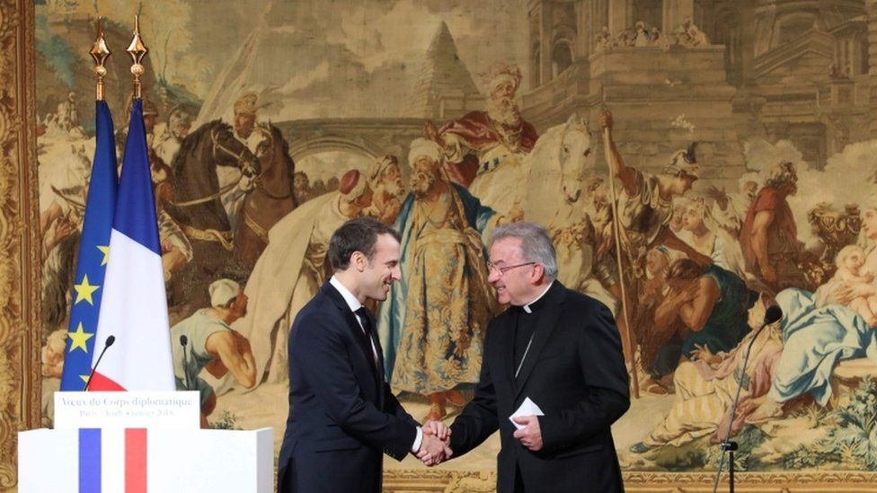 Luigi Ventura shaking hands with Emmanuel Macron