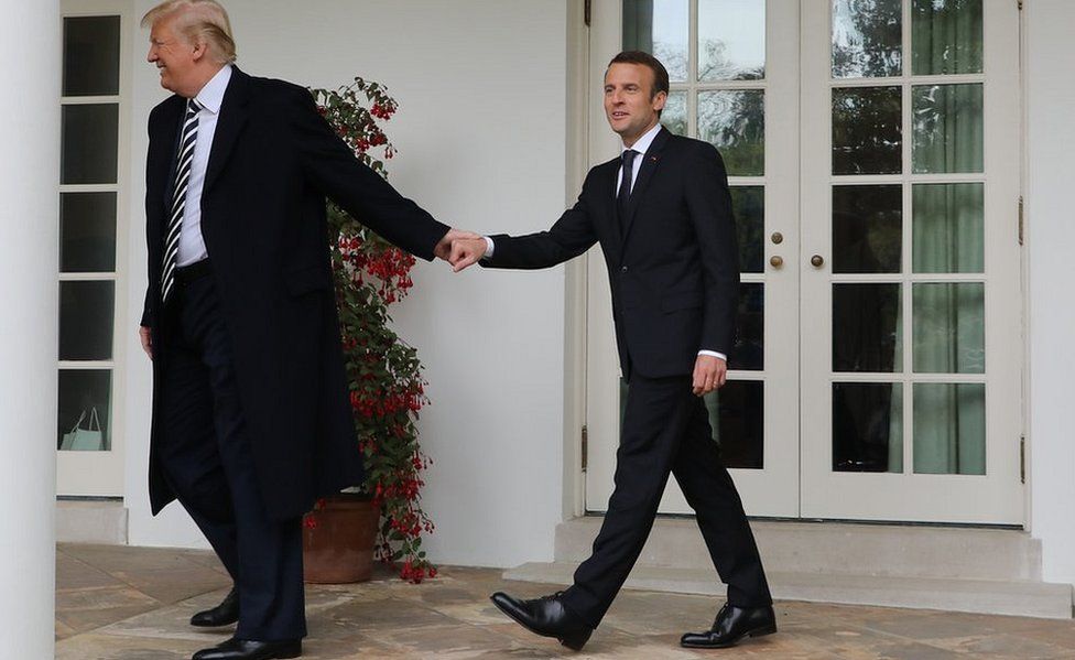 French President Emmanuel Macron (R) and US President Donald Trump (R) walk hand in hand at the White House, 24 Apr 2018