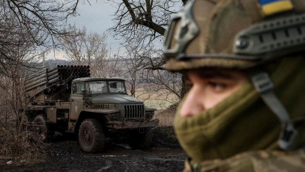File image of a Ukrainian solider and a military vehicle in a wintry scene