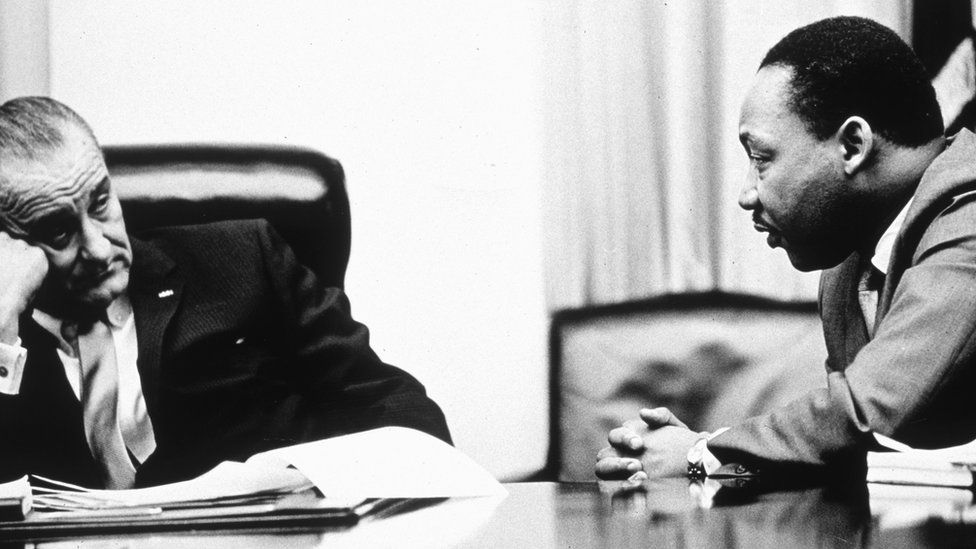 President Lyndon B Johnson (1908 - 1973) discusses the Voting Rights Act with civil rights campaigner Martin Luther King Jr. (1929 - 1968).