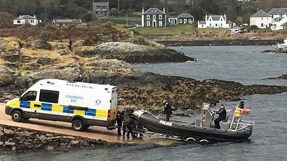 Police divers with boat and van