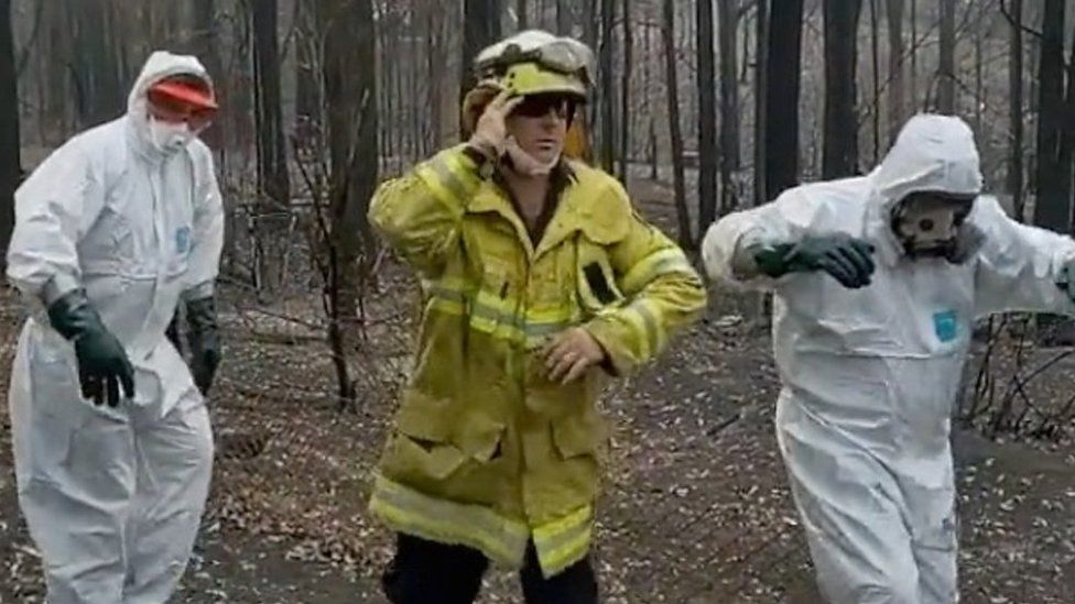 Three firefighters dance in a TikTok video