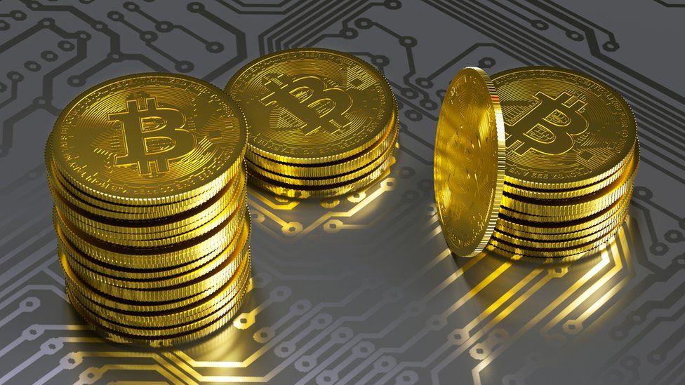 Gold bitcoins on circuit board graphic