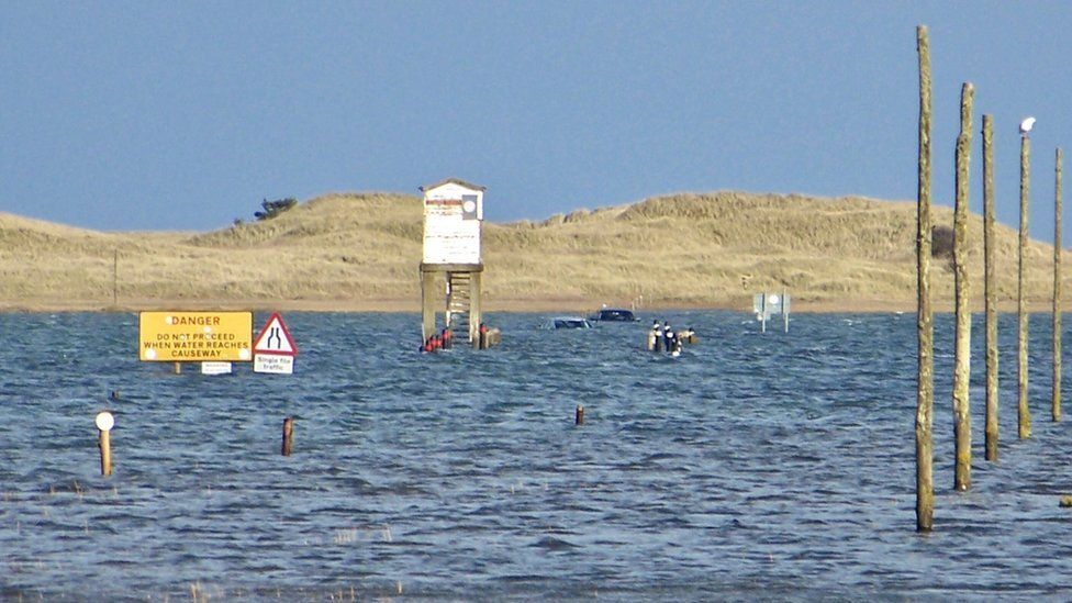 Cars submerged on the Holy Island causeway