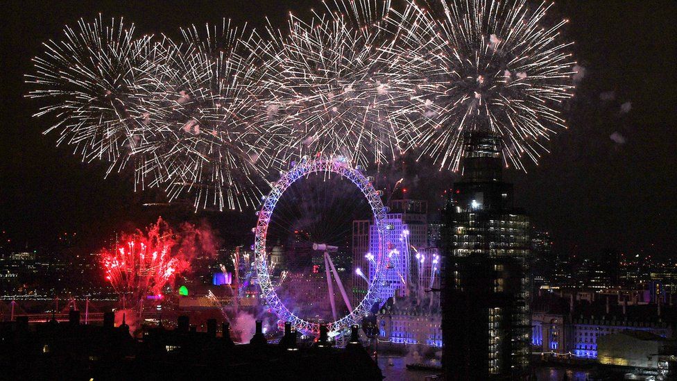 London Eye surrounded by exploding fireworks