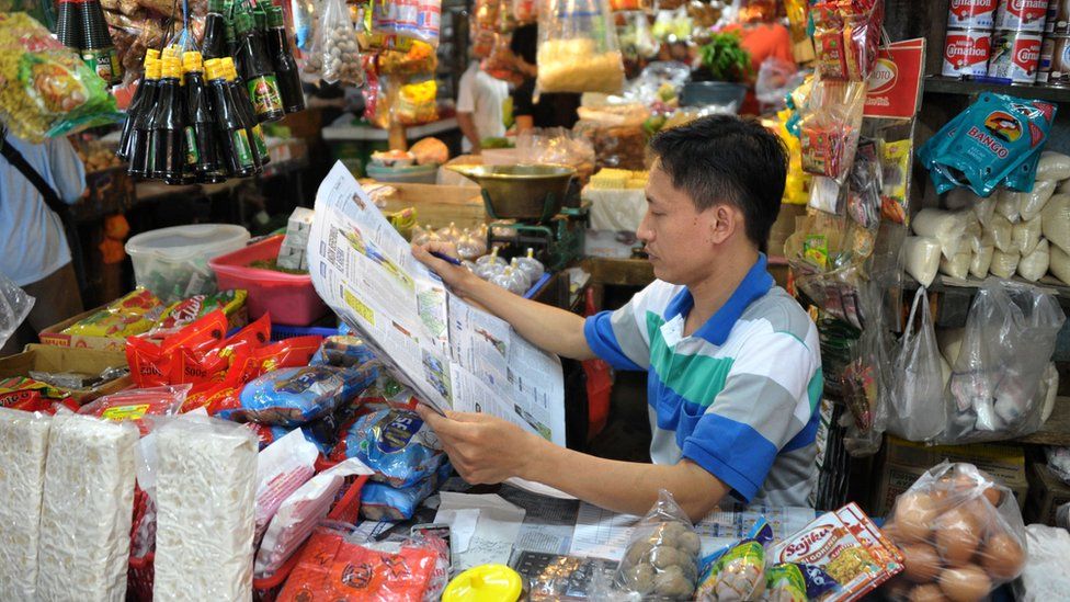 Newspaper reader in Indonesia