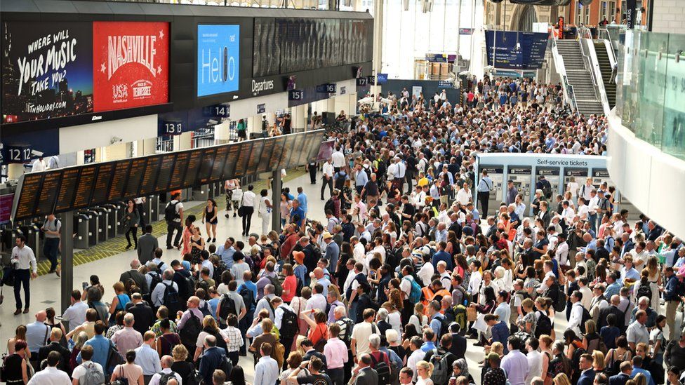Crowd of commuters at Waterloo Station in London
