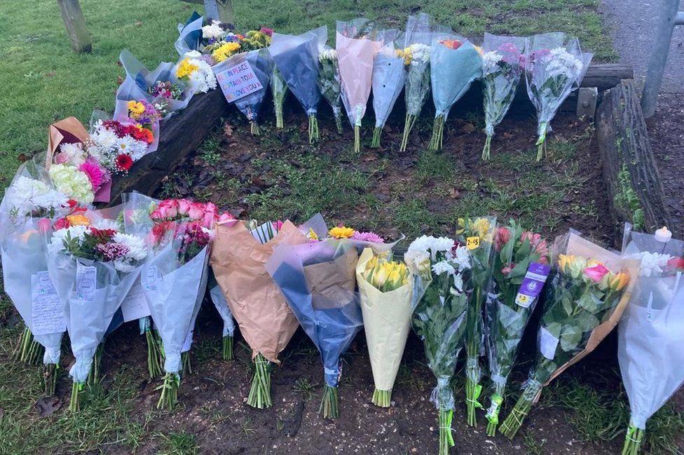 People have been leaving floral tributes outside Capt Sir Tom's home