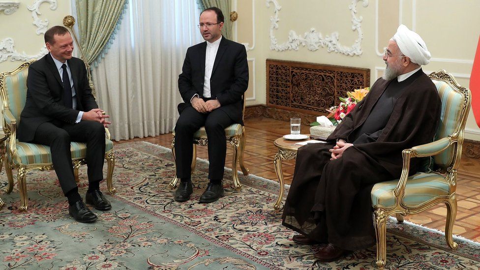 French envoy Emmanuel Bonne (L) speaks to Iranian President Hassan Rouhani in Tehran on 10 July 2019