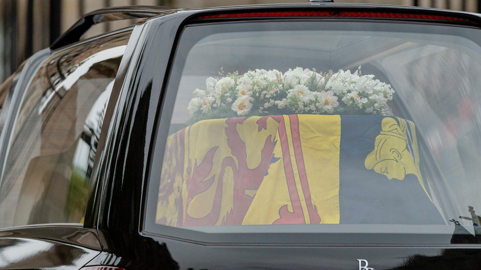 The coffin of Queen Elizabeth II is carried in the back of a hearse