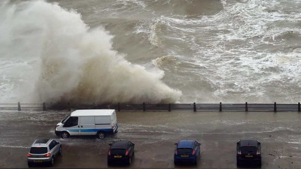 Waves crash over the wall at Newhaven Harbour, East Sussex