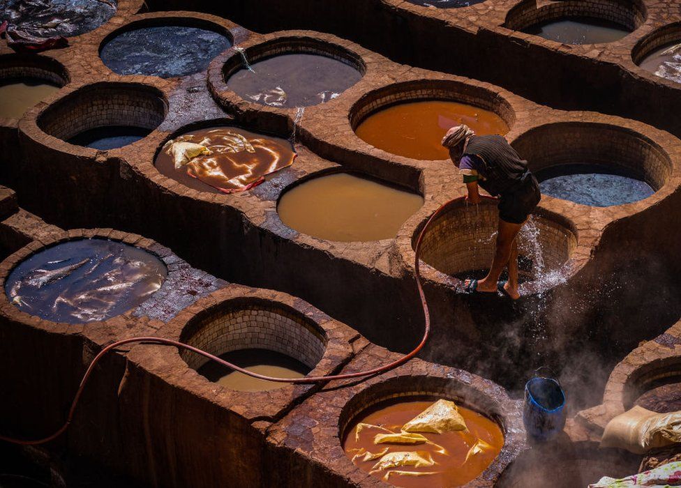 A worker cleans himself at a tannery within the medina of Fes (Fez). 03 April 2023.