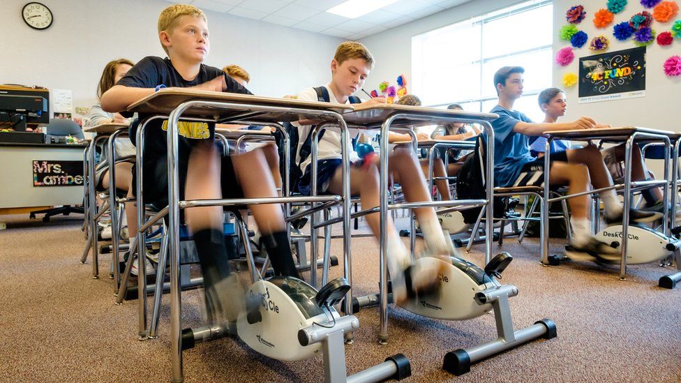 Pupils with bike pedals under their desks