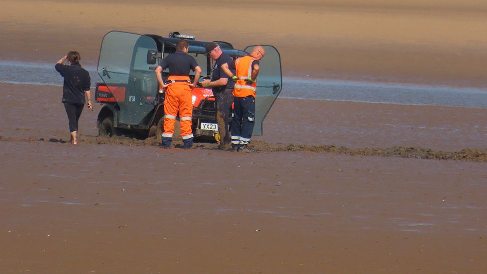 Buggy trapped in mud on beach