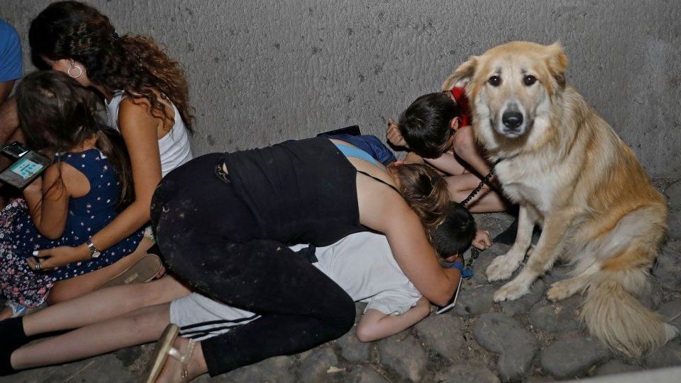 A family in Israel takes shelter under a bridge in Tel Aviv after rockets were fired from Gaza