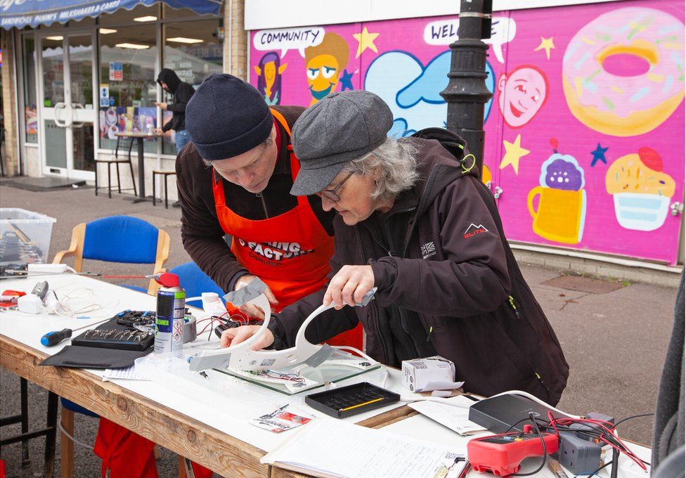 Volunteers repair electrical items at the Fixing Factory in Camden, London