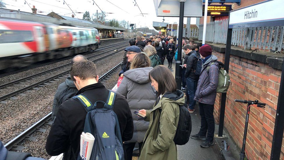People waiting on a crowded platform at Hitchin station, where commuters were hit by early morning cancellations and delays after a freight train derailed.