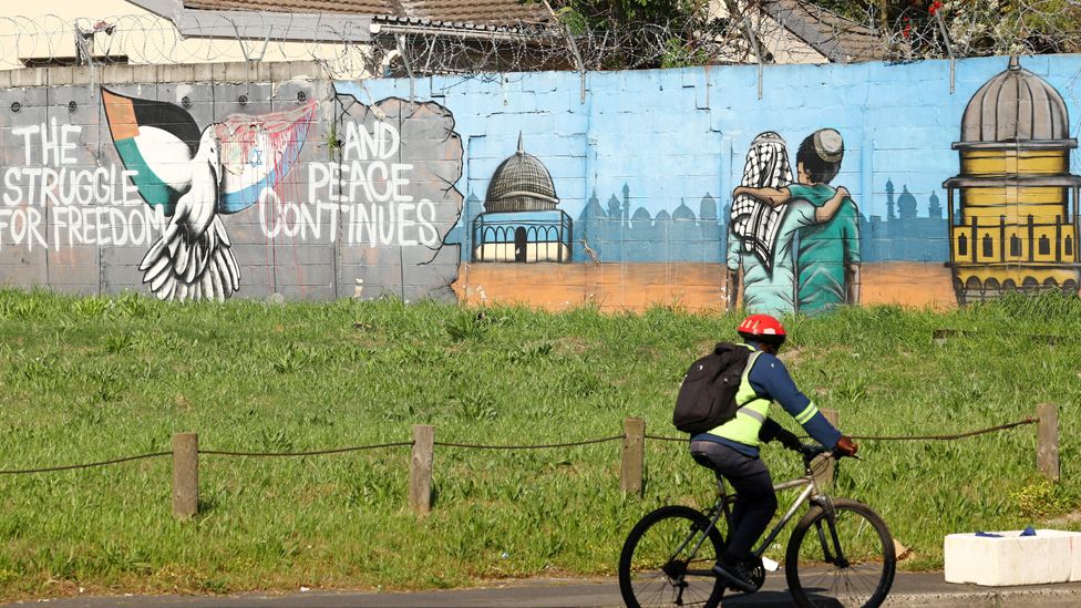 A cyclist rides past a mural symbolising freedom and peace between Israel and Palestinians in Cape Town, South Africa - Wednesday 11 October 2023