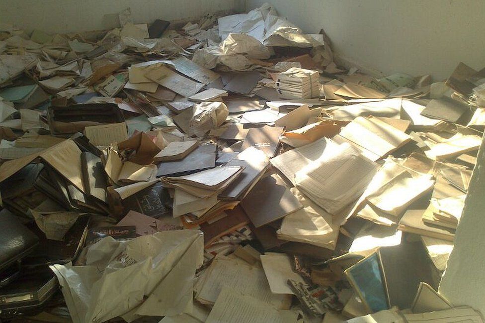 Documents cover the floor of Baath Party offices, northern Syria (September 2013)