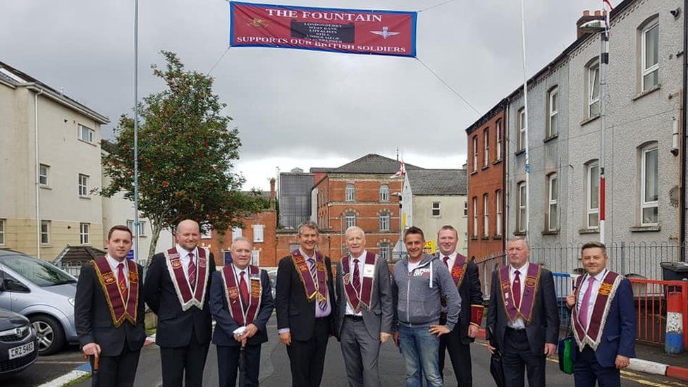 Members of the Democratic Unionist Party were pictured beneath a banner supporting British soldiers